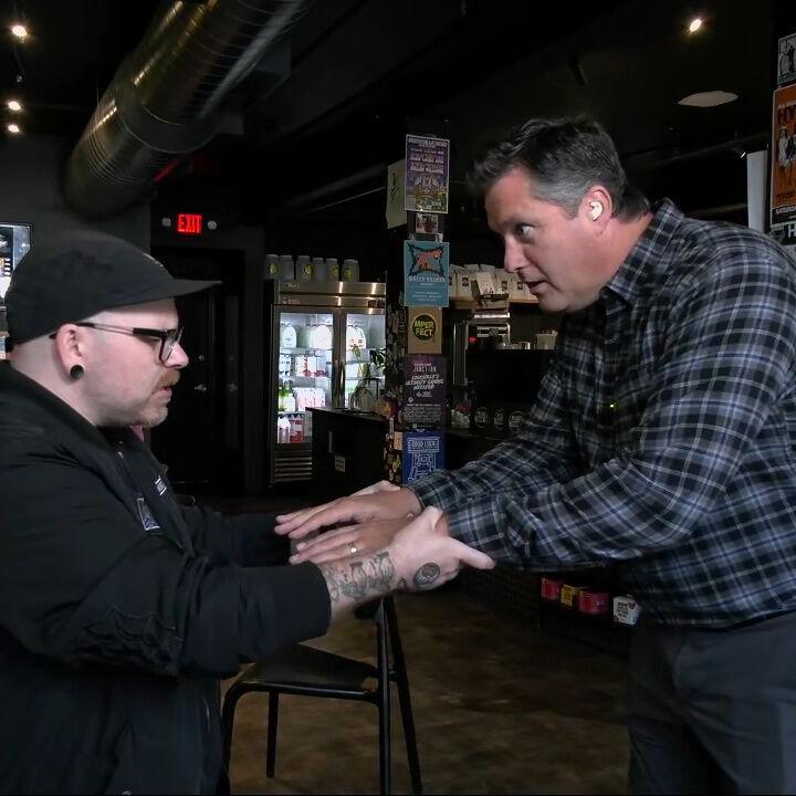 Keith Kaiser does a magic trick with magician Jared Howell